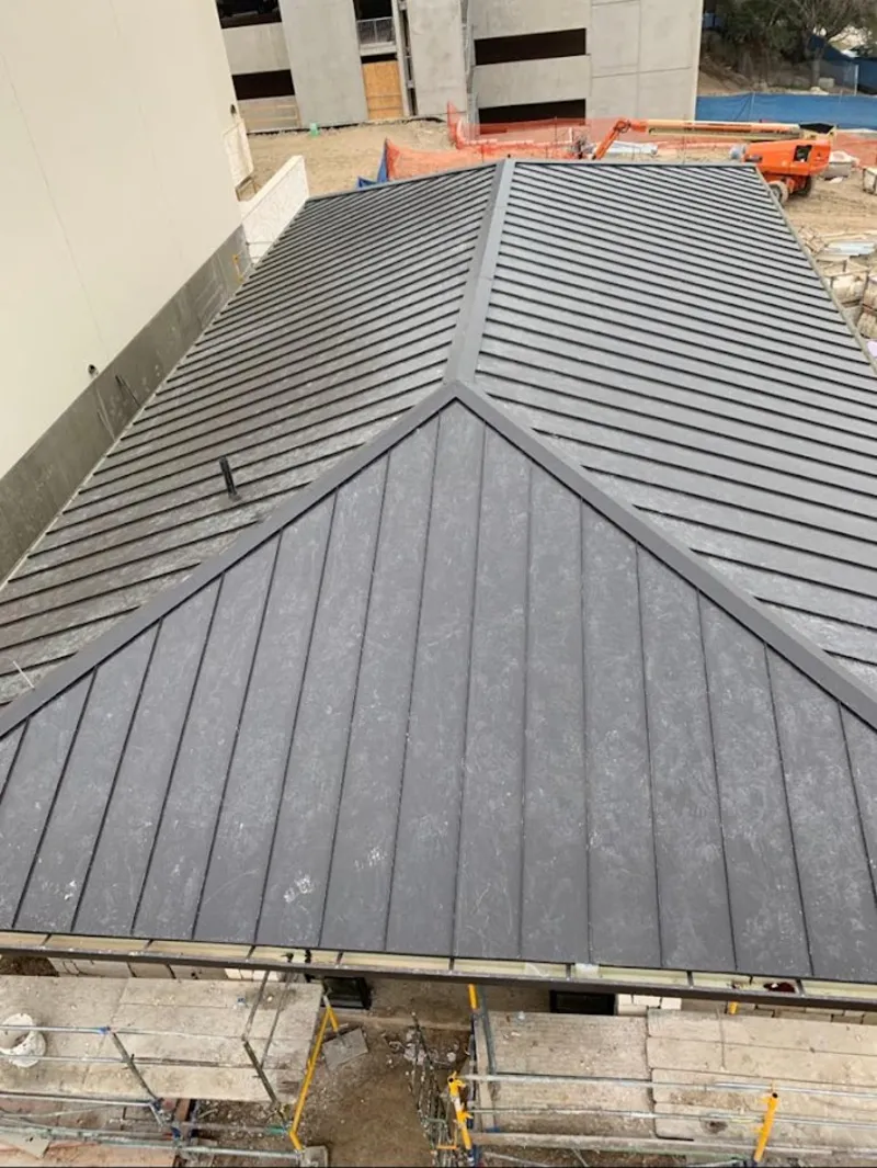 Commercial metal roof construction with crane equipment in Sunrise Manor